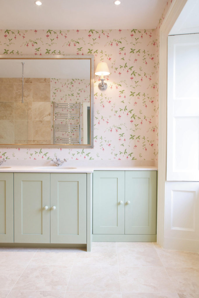 Muted tones and Colefax & Fowler wallpaper in a muted bathroom