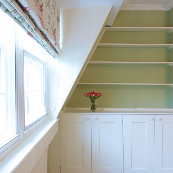 Utilising quirky nooks for storage in the guest bedroom