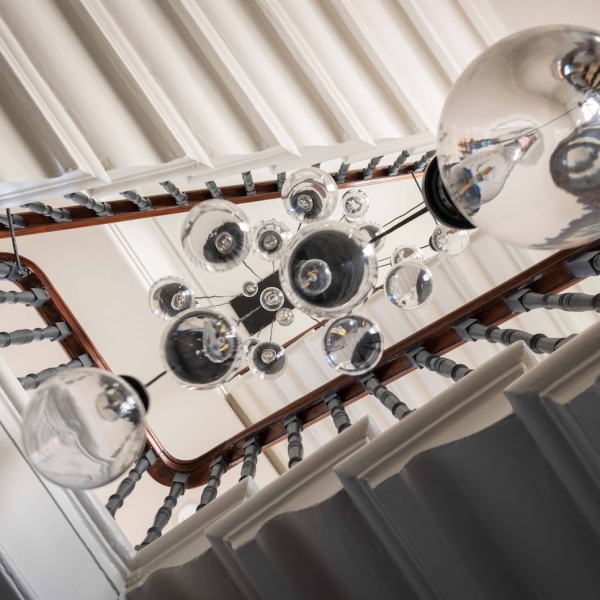 Waterfall chandelier over stairs